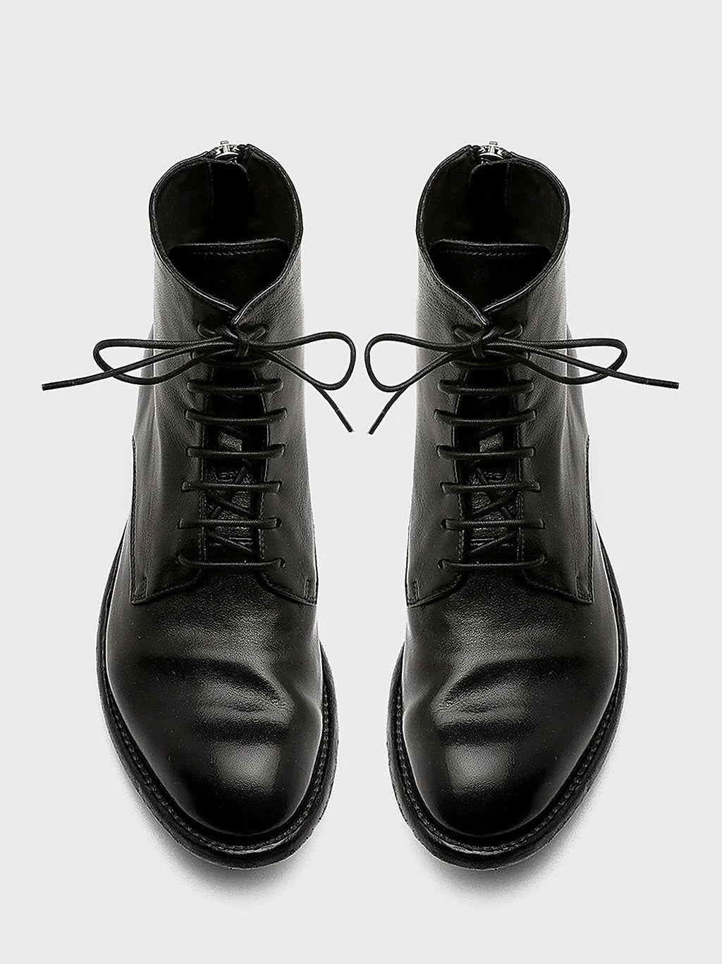 Black rear zip pair arranged together on a neutral ground