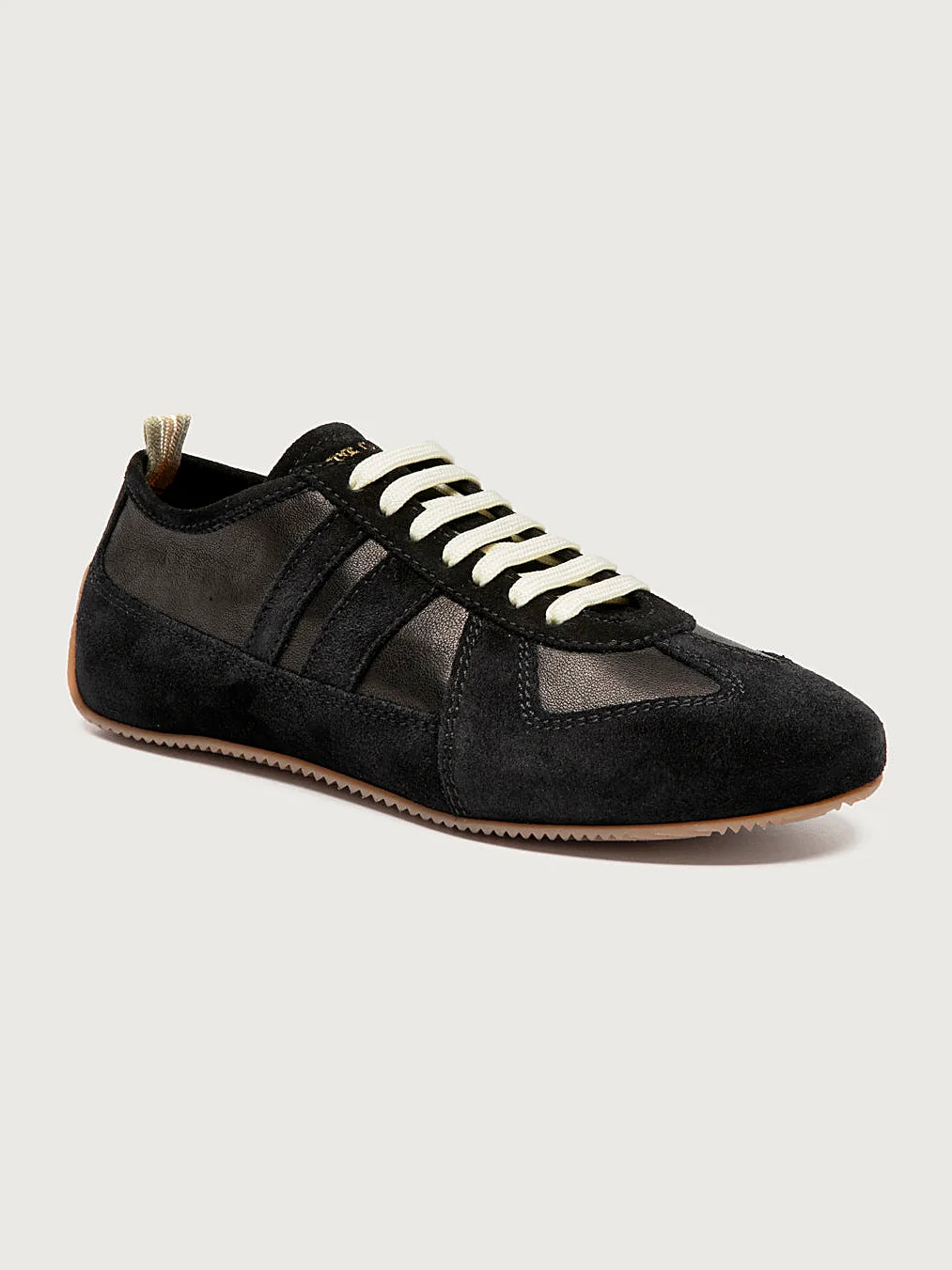 Black sneakers white-laced front view showing the shape of the toe