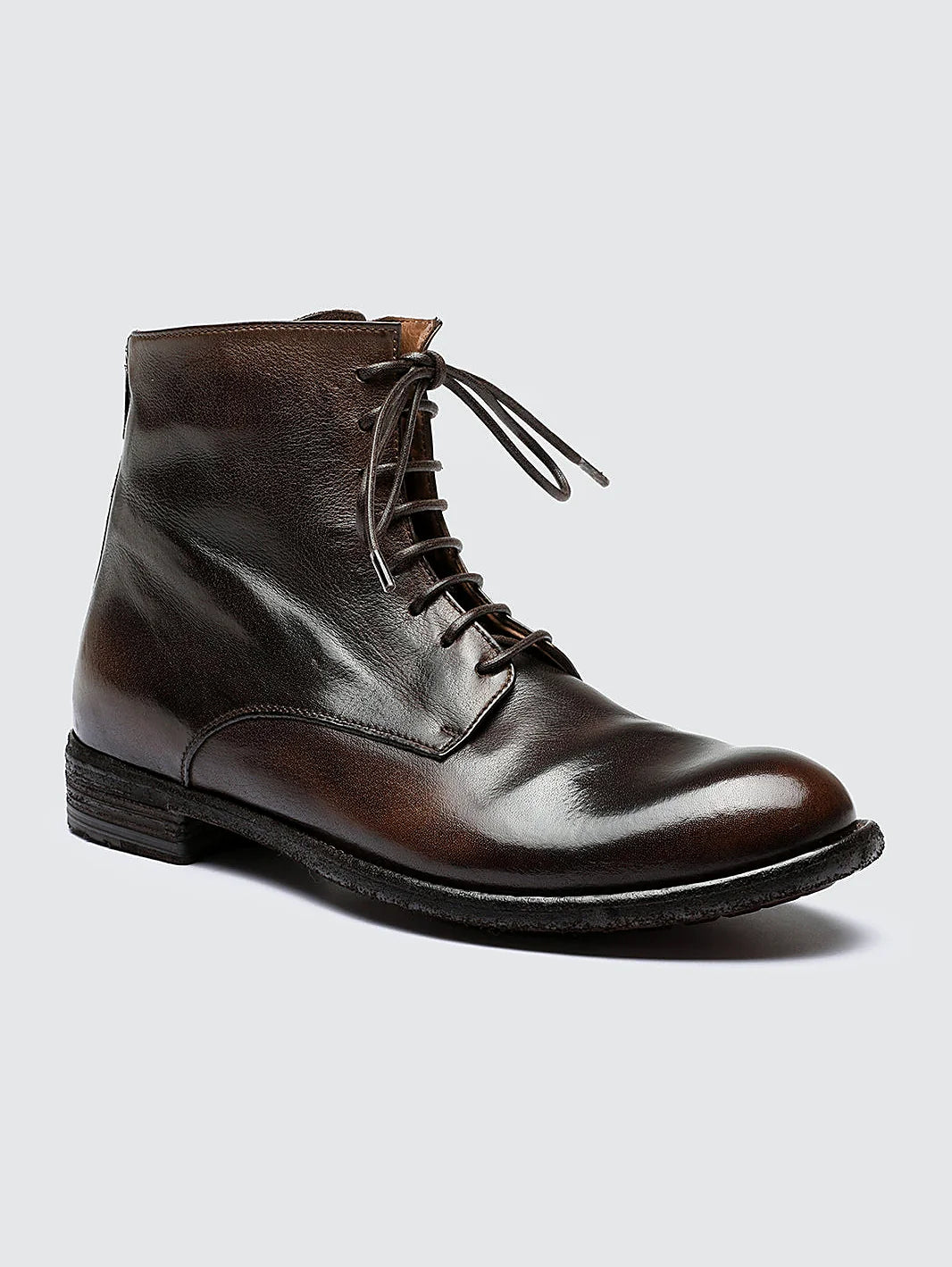 Brown back zip pair arranged together on a neutral ground