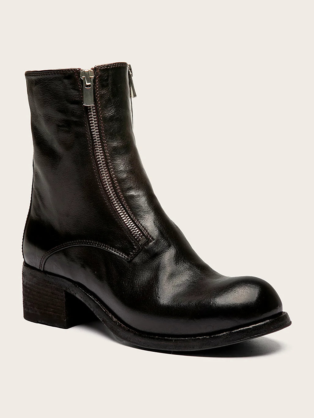 Brown leather sole pair arranged together on a neutral ground