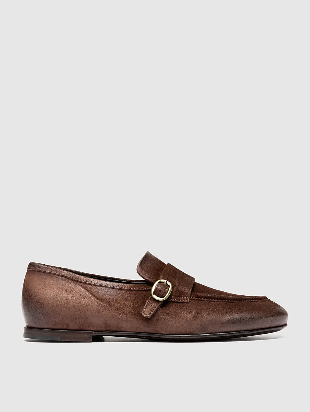 Brown side buckle close view of the heel and sole edge