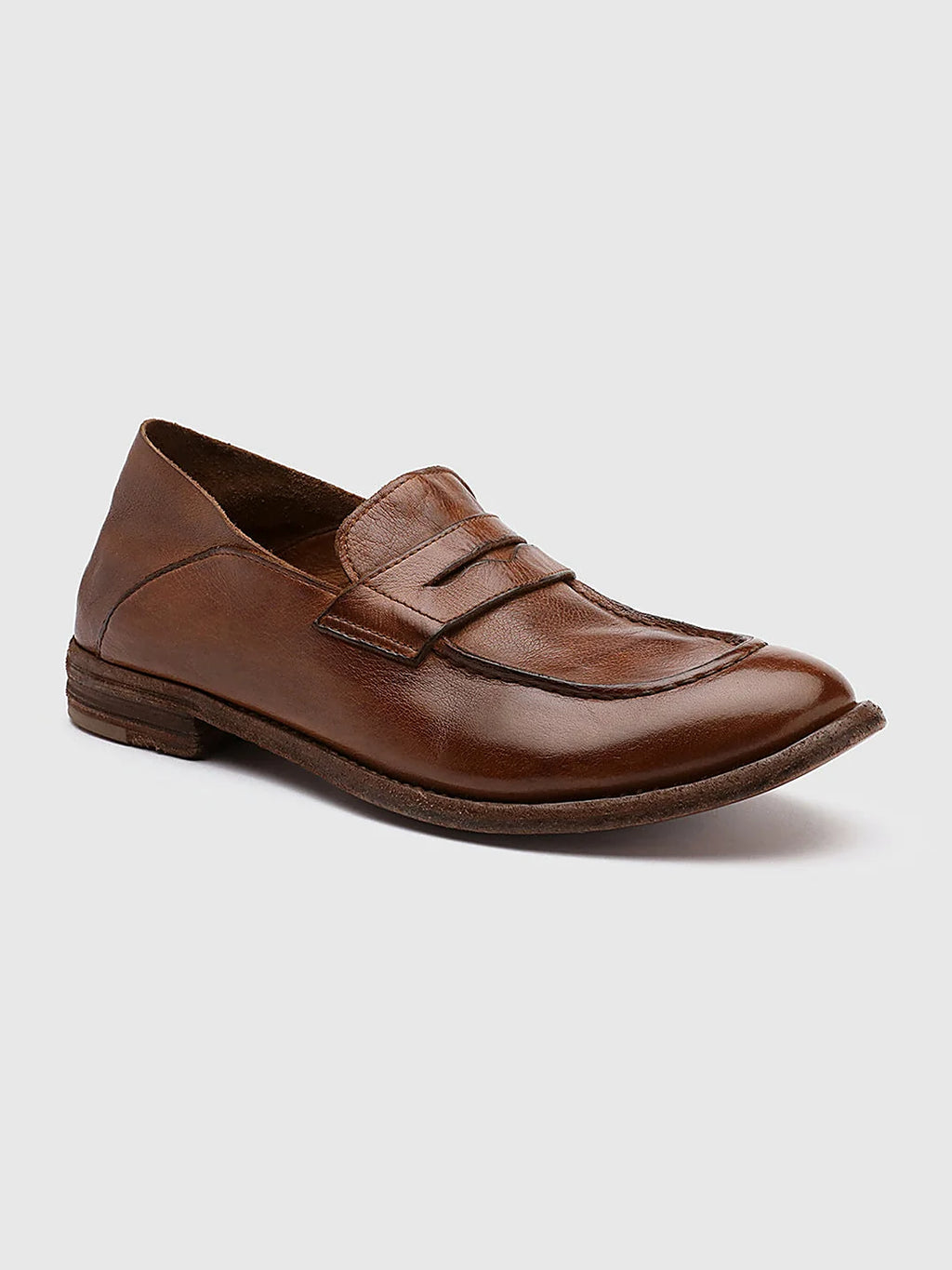 Brown leather loafers seen at an angle showing the toe