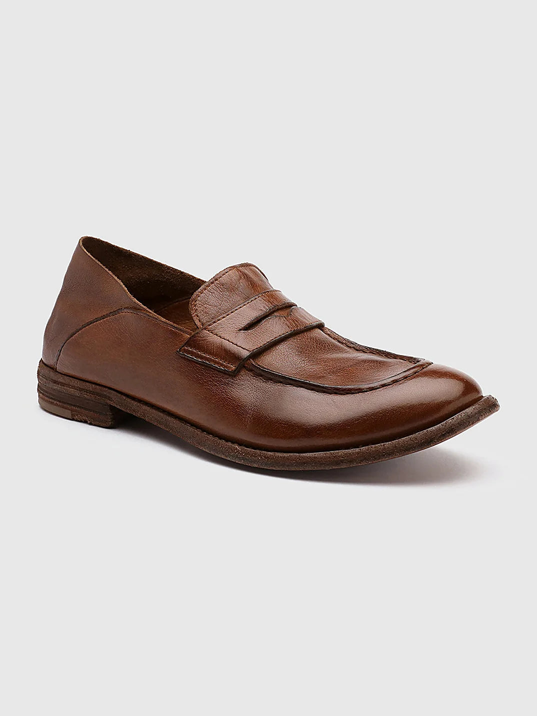 Brown leather loafers seen at an angle showing the toe