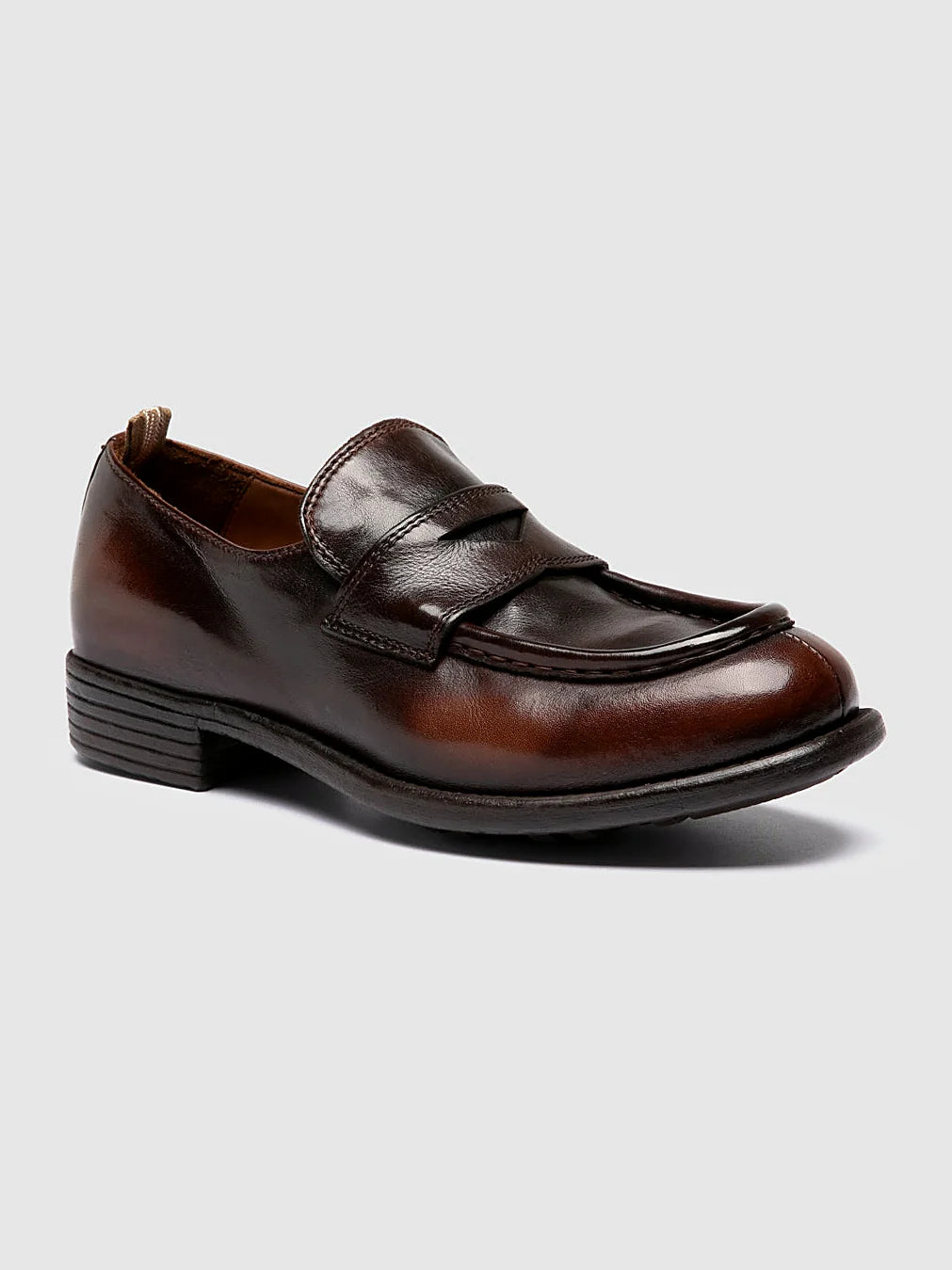 Brown loafers rubber-soled shown from the side on a plain background