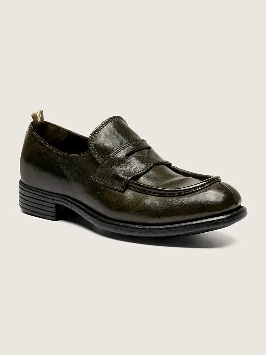 Green leather loafers pair arranged together on a neutral ground