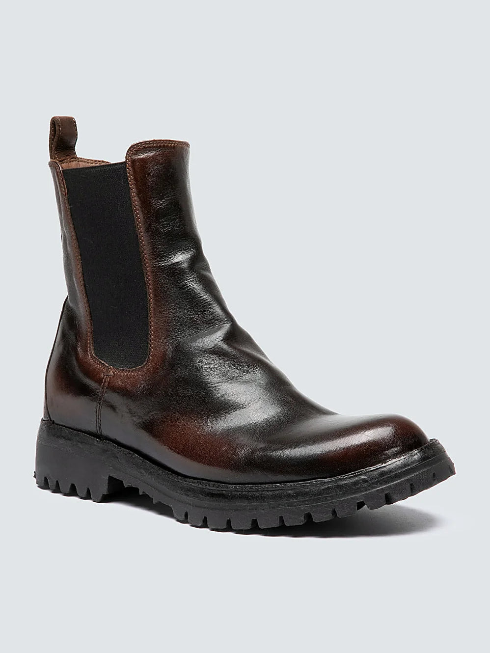 Brown chelsea boots pair arranged together on a neutral ground
