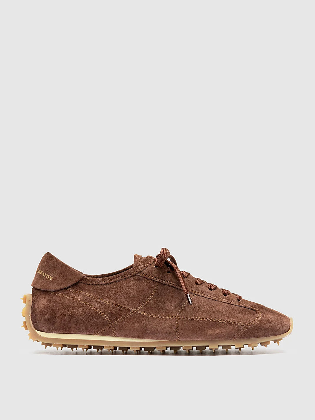 Brown suede sneakers close view of the heel and sole edge