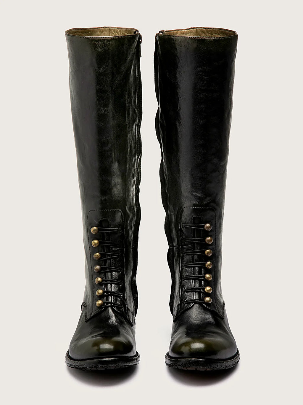 Brown side zip pair arranged together on a neutral ground