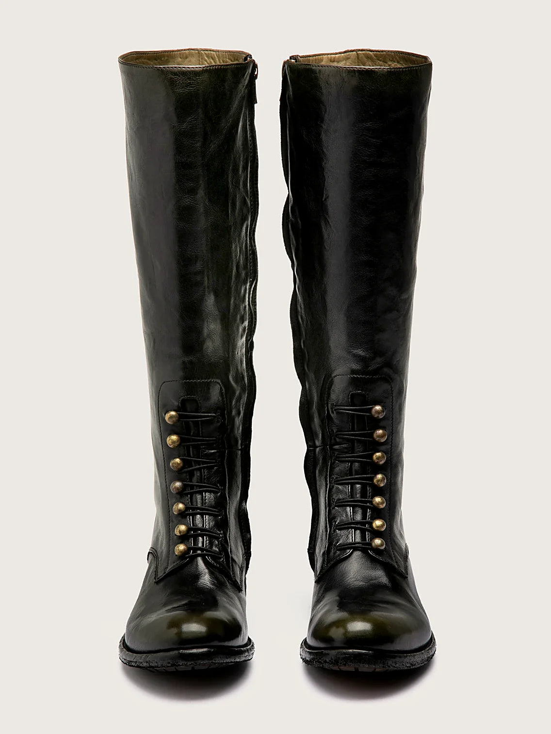 Brown side zip pair arranged together on a neutral ground